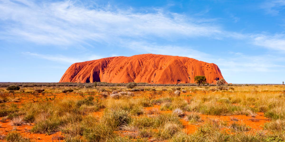 Capture the majestic beauty of Uluru in Australia, a highlight of the journey spanning 21 countries, tailored for self-flying pilots. Experience the spiritual enormity of this iconic landmark, revered by indigenous communities, amidst the breathtaking landscape of Australia's heartland.