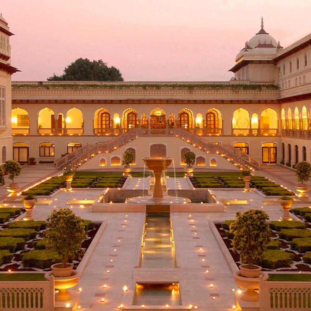 A majestic palace surrounded by lush gardens and reflecting pools, Rambagh Palace is a luxury hotel located in Jaipur, India. Formerly a royal residence, it exudes opulence and grandeur, offering guests a regal experience amidst historic charm and modern comforts.