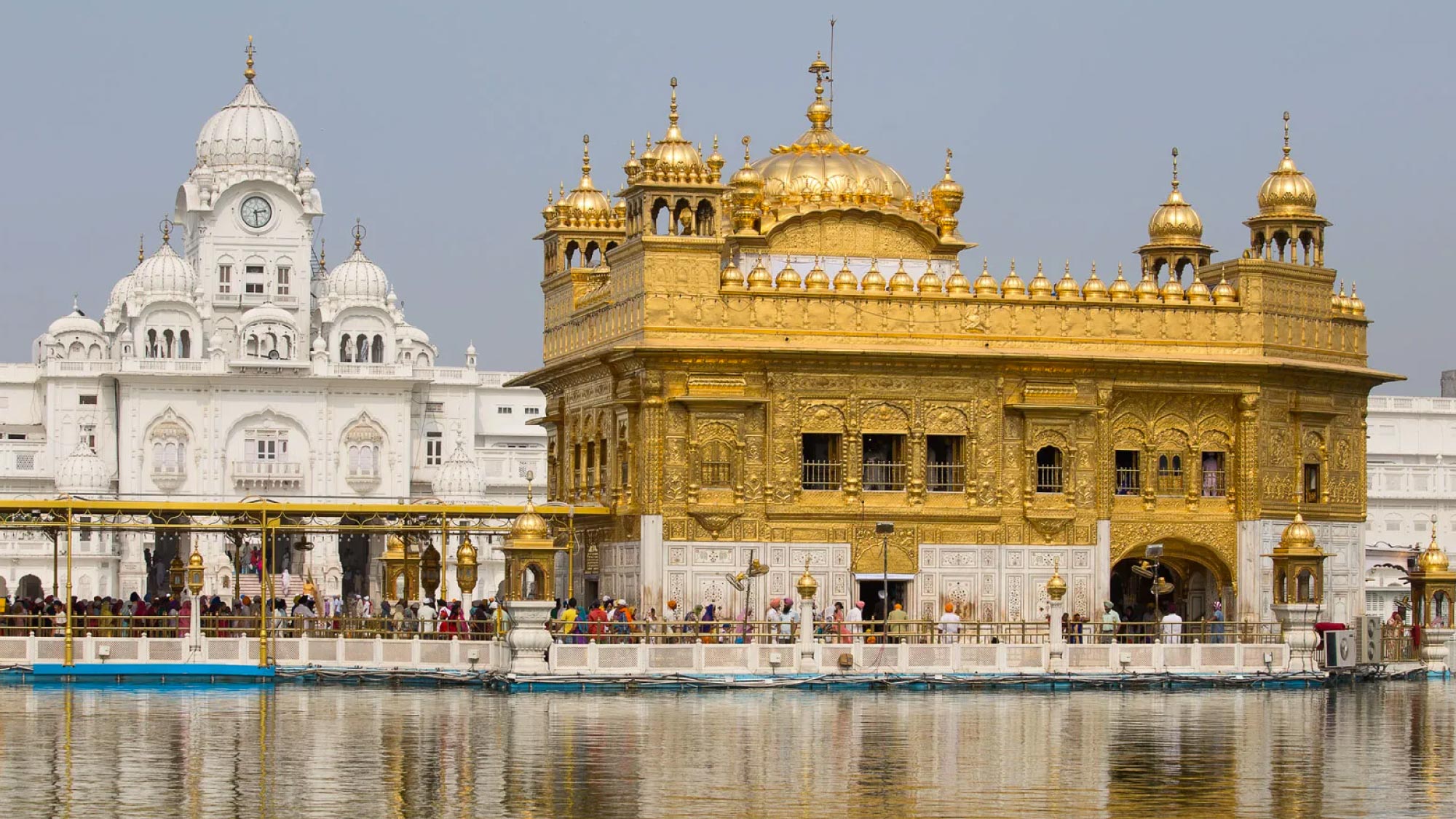 A captivating image showcasing the vibrant cityscape of Amritsar, India, with the iconic Golden Temple shining amidst the skyline. This destination is a highlight of a journey to Australia, visiting 21 countries, ideal for travelers who fly and own their own airplanes.