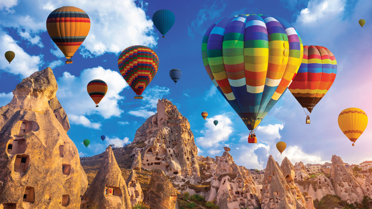 Hot air balloons soaring over Cappadocia, Turkey, captivate self-flying pilots with their own aircraft, offering a breathtaking perspective of Eurasia's stunning landscapes and cultural wonders from the skies above.