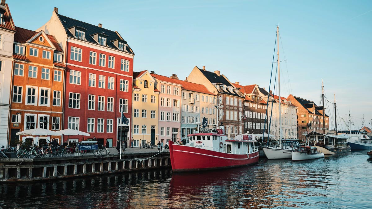 Sailboats docked on Nyhavn Harbour in Copenhagen, Denmark, inviting self-flying pilots with their own aircraft to embark on a European voyage filled with maritime charm and Scandinavian allure.