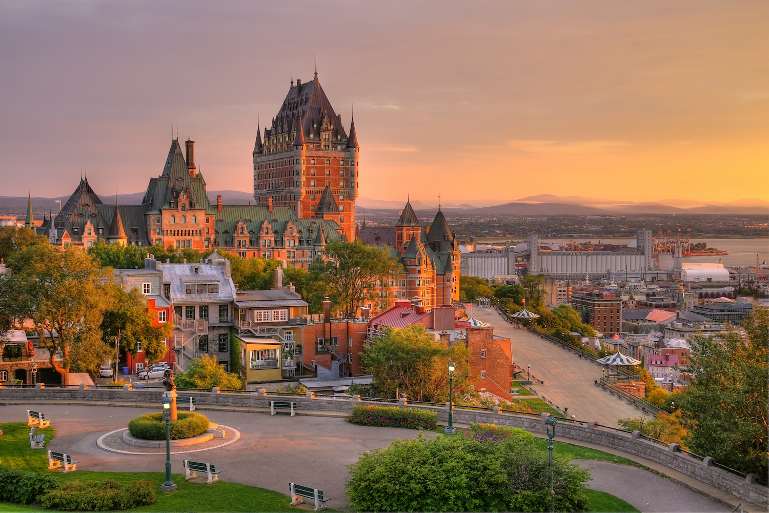 A charming view of the historic Old Town area of Quebec City, Canada, showcasing cobblestone streets, colorful buildings, and a bustling atmosphere. This image promotes a journey tailored for pilots flying their own airplanes to Greenland and Iceland, highlighting the departure point in Quebec City.