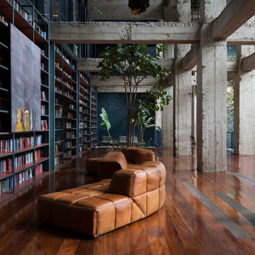 A glimpse into the stylish lobby of Stamba Hotel in Tbilisi, Georgia. The industrial design is highlighted by a floor-to-ceiling library, creating a sophisticated and visually striking atmosphere. Guests are welcomed into a unique blend of contemporary elegance and literary charm in the heart of Tbilisi.
