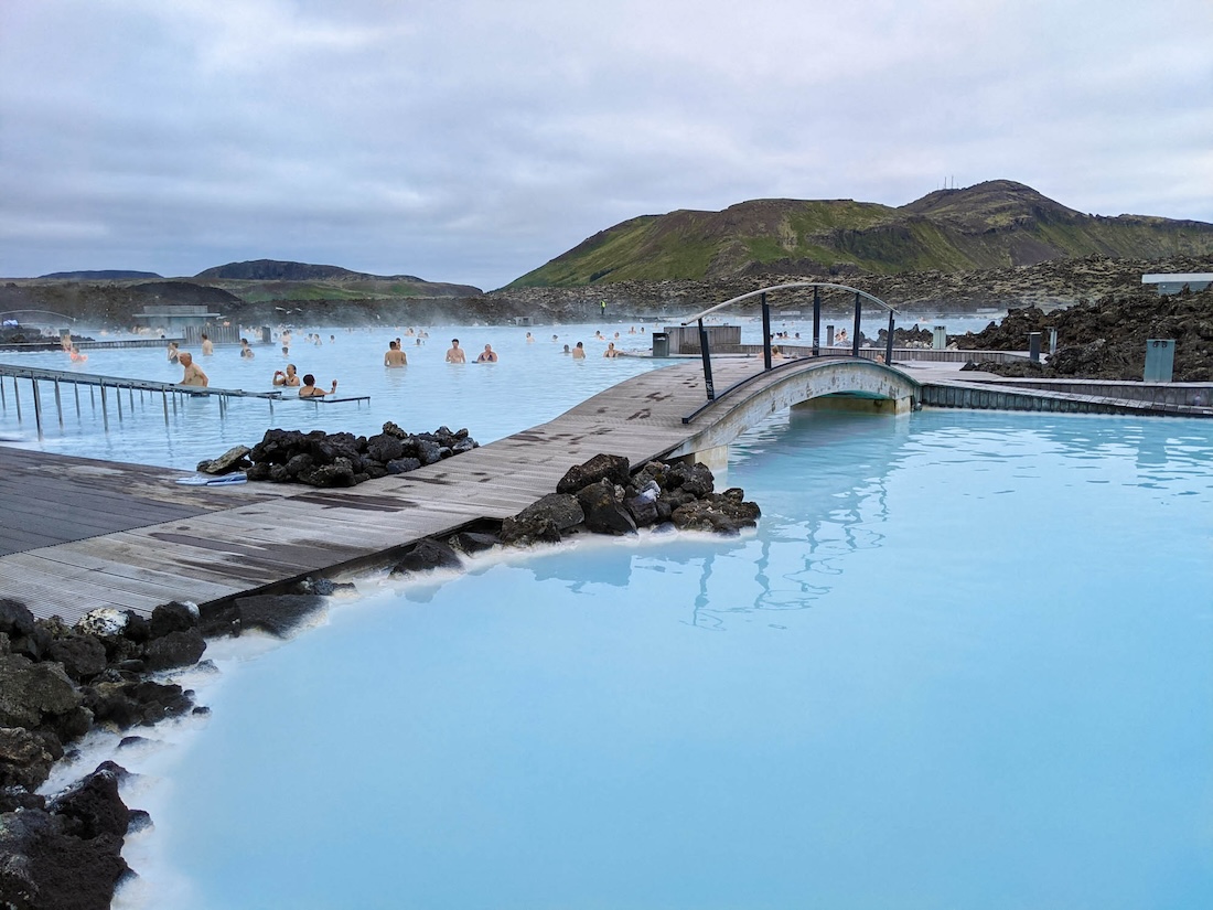 View of the iconic Blue Lagoon in Reykjavik, Iceland, surrounded by stunning turquoise waters and rugged volcanic landscapes. This captivating image captures the allure of Iceland's natural wonders, enticing pilots embarking on their own airplane adventure to Greenland and Iceland with promises of unforgettable experiences in this breathtaking destination.