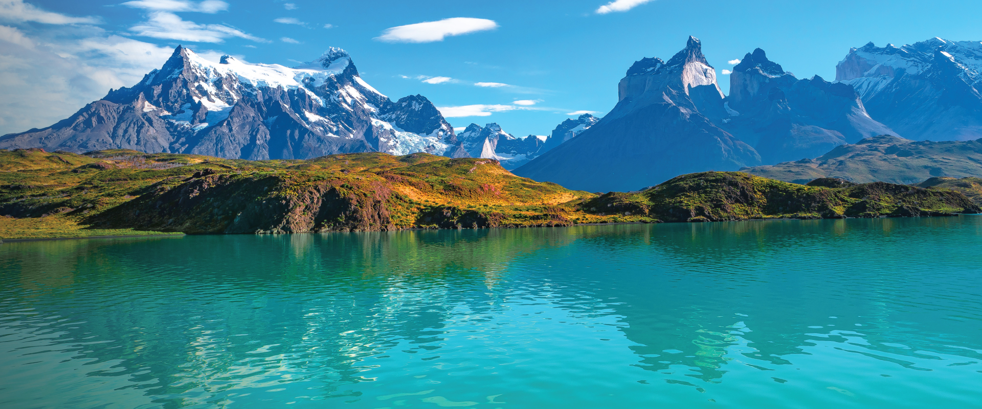 An enchanting aerial view of a serene lake nestled within the pristine wilderness of Chilean Patagonia, surrounded by towering mountains and lush forests. A captivating destination for self-flying pilots exploring South America