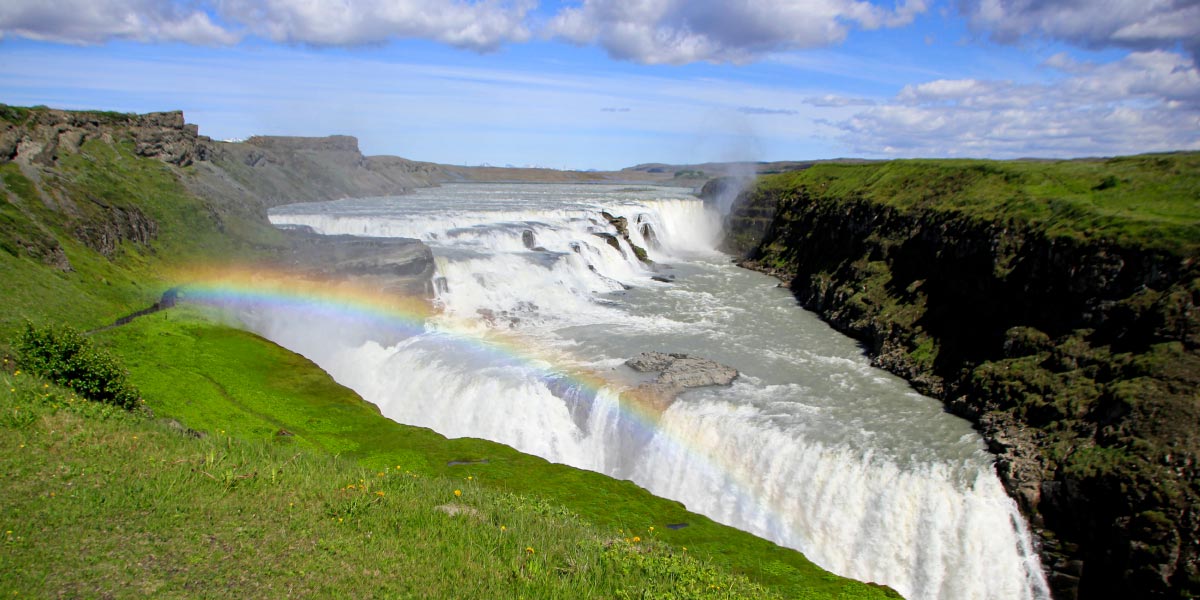 View of Iceland's Gulfoss waterfall, showcasing powerful cascading water amidst stunning natural landscapes to be seen on our self-fly Journey to Iceland