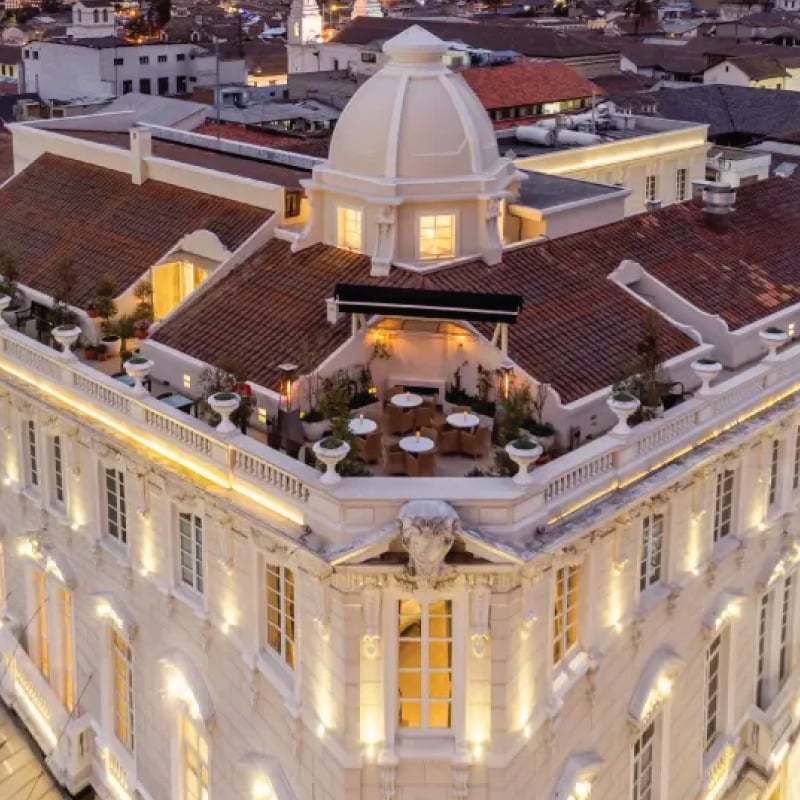A picturesque view of Casa Gangotena, a historic mansion in the heart of Quito, Ecuador, surrounded by colonial architecture and vibrant streets. A charming destination for self-flying pilots exploring South America, Casa Gangotena offers a luxurious retreat amidst the cultural richness and aerial allure of Quito's skyline.
