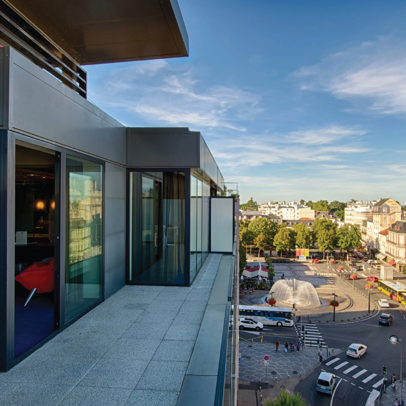 An image of the balconies of Le Rex Hotel in Tarbes, France, offering a glimpse of the city's urban charm and hospitality. Tailored for self-flying pilots