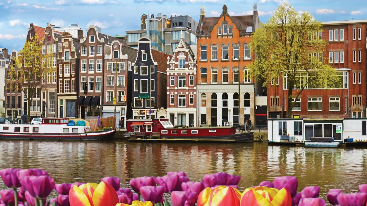 A captivating view of Amsterdam, Netherlands, showcasing its iconic canals, historic architecture, and vibrant cityscape. Tailored for self-flying pilots planning a European journey