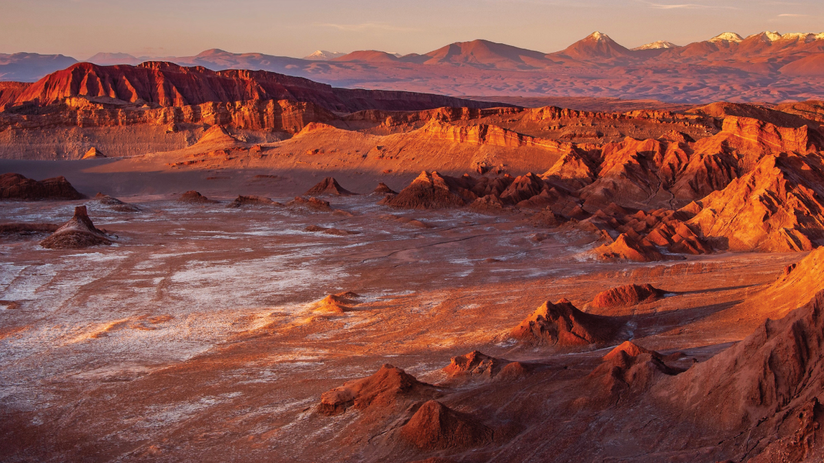 A breathtaking aerial panorama of the Atacama Desert in Chile, showcasing its vast expanse of otherworldly landscapes, rugged terrain, and surreal geological formations. A captivating destination for self-flying pilots exploring South America