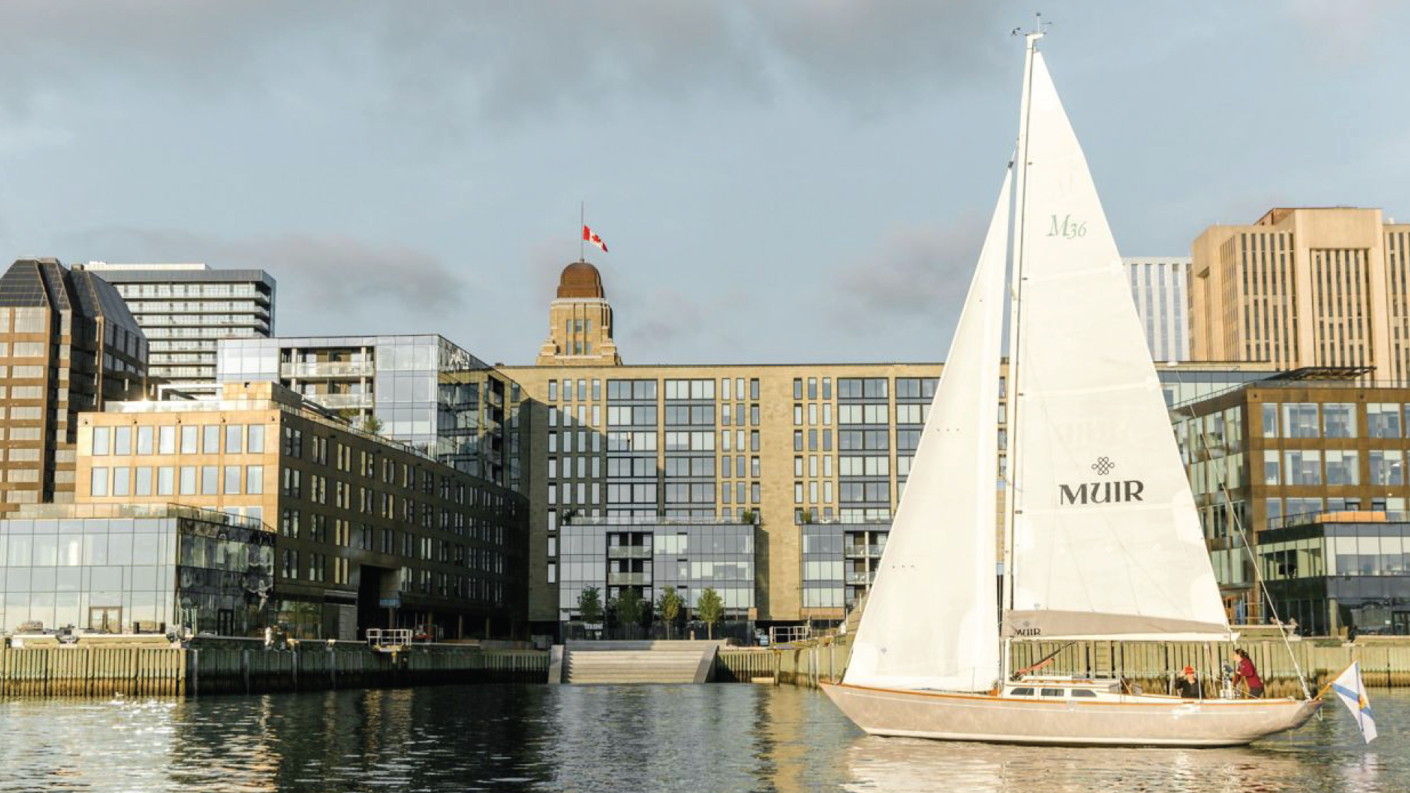 A scenic view of a sailboat from the Muir Hotel in Halifax, Nova Scotia, set against the backdrop of the picturesque harbor and waterfront. Tailored for self-flying pilots