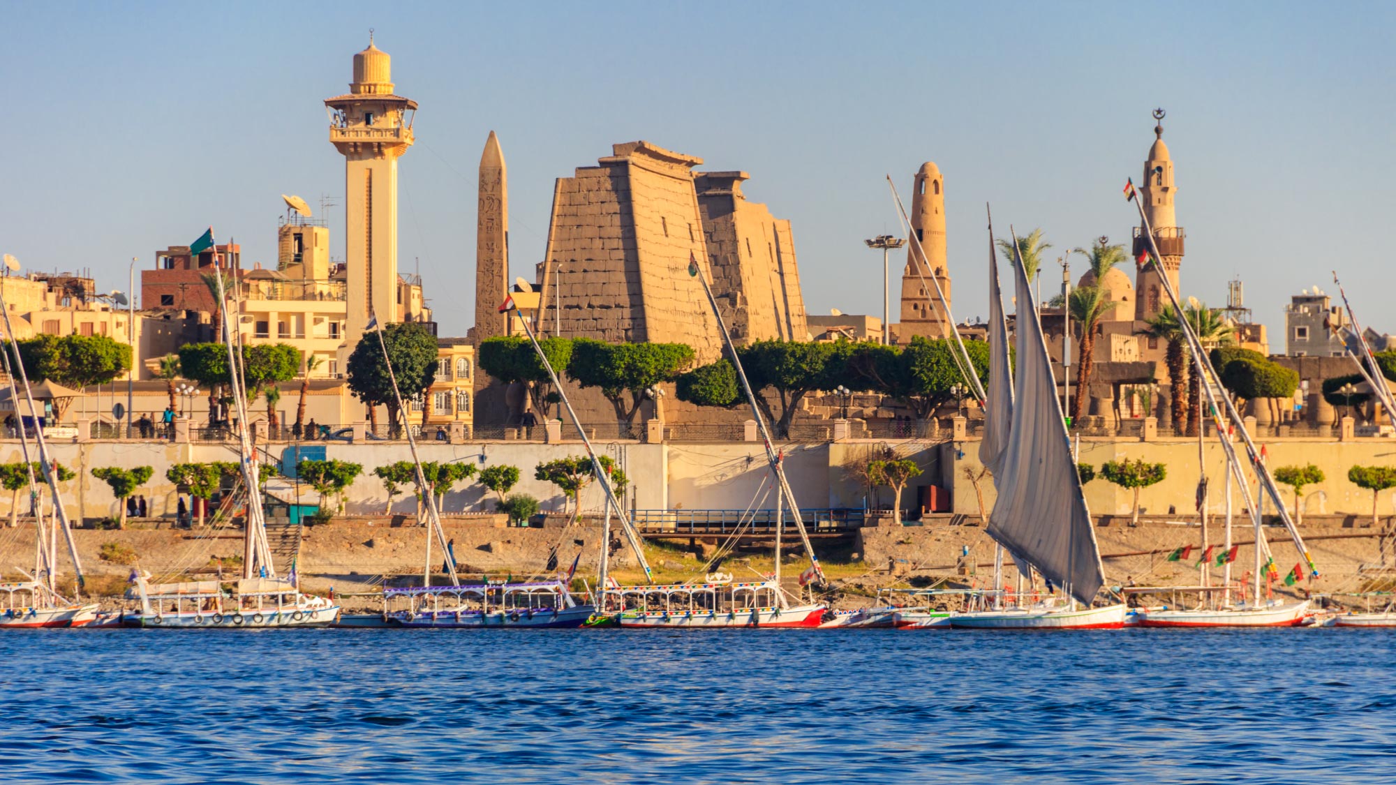 A captivating view of Luxor, Egypt, featuring ancient temples, the serene Nile River, and the charming village of Karnak. This historic city is renowned for its stunning archaeological sites and rich cultural heritage