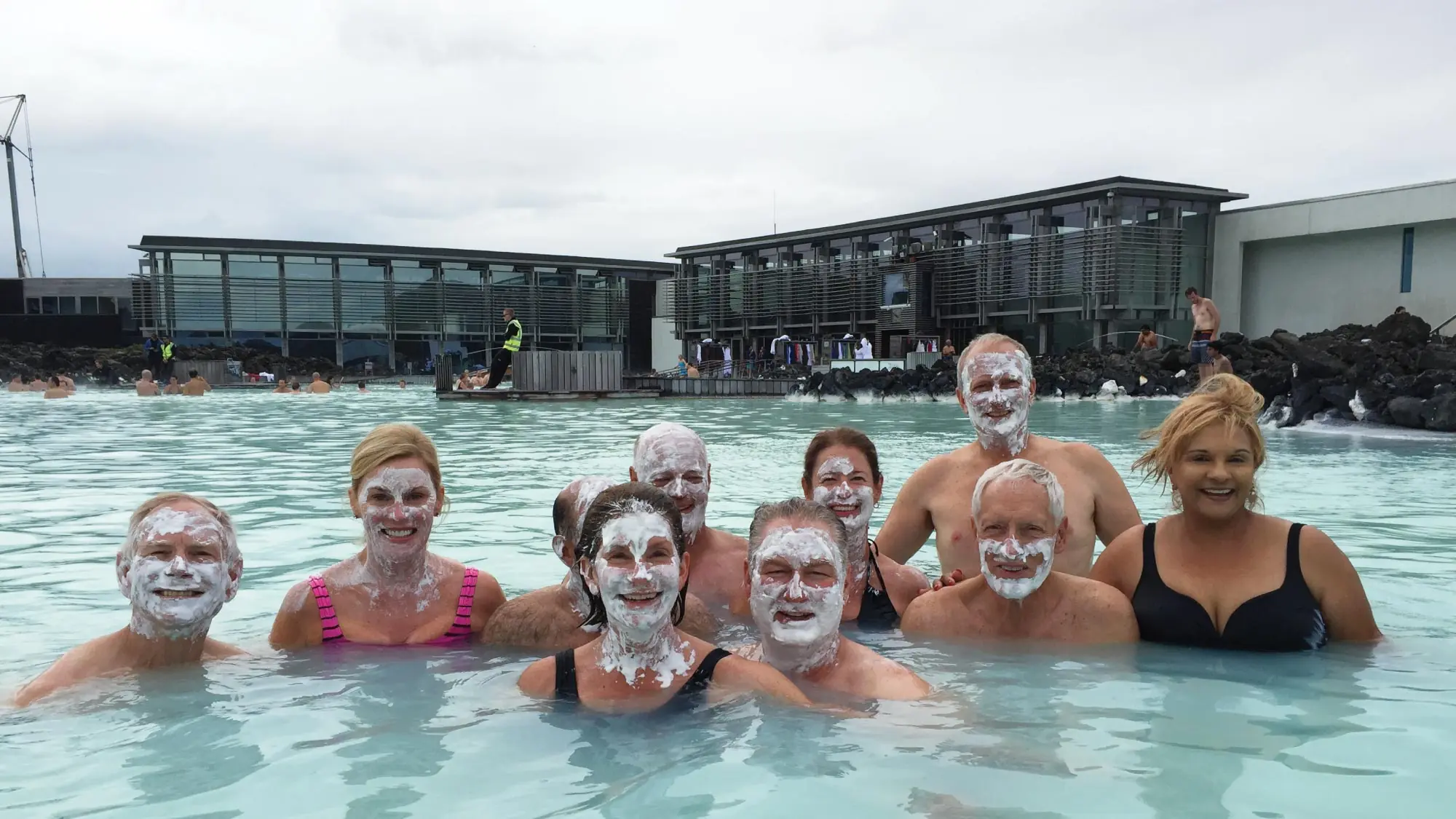 Friends laugh and unwind in the soothing turquoise waters of Iceland's iconic Blue Lagoon